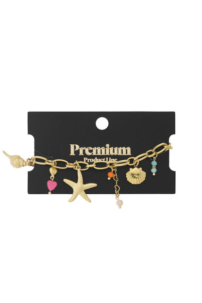 Gold chain bracelet with nautical charms: starfish, seashells, colorful beads, and a pink heart on a black display card.