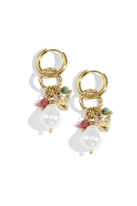 Pair of gold-tone hoop earrings with dangling faux pearl, pink stone, turquoise bead, and heart charms displayed on white background