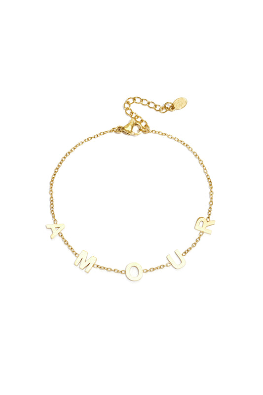 Gold chain bracelet with the letters A M O U R spaced evenly across a delicate link chain and adjustable lobster clasp