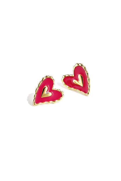 Pair of heart-shaped stud earrings with hot pink enamel centers and gold-tone textured edges on a white background