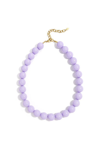 Vibrant purple chunky resin beaded necklace with gold chain clasp photographed on white background