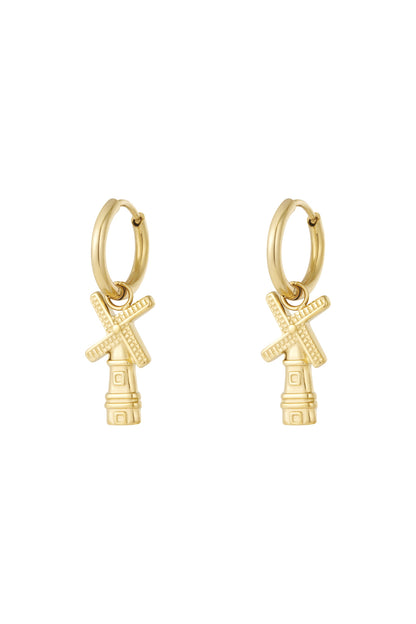 Pair of gold windmill charm hoop earrings with detailed blades on white background