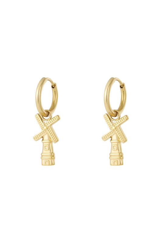 Pair of gold windmill charm hoop earrings with detailed blades on white background
