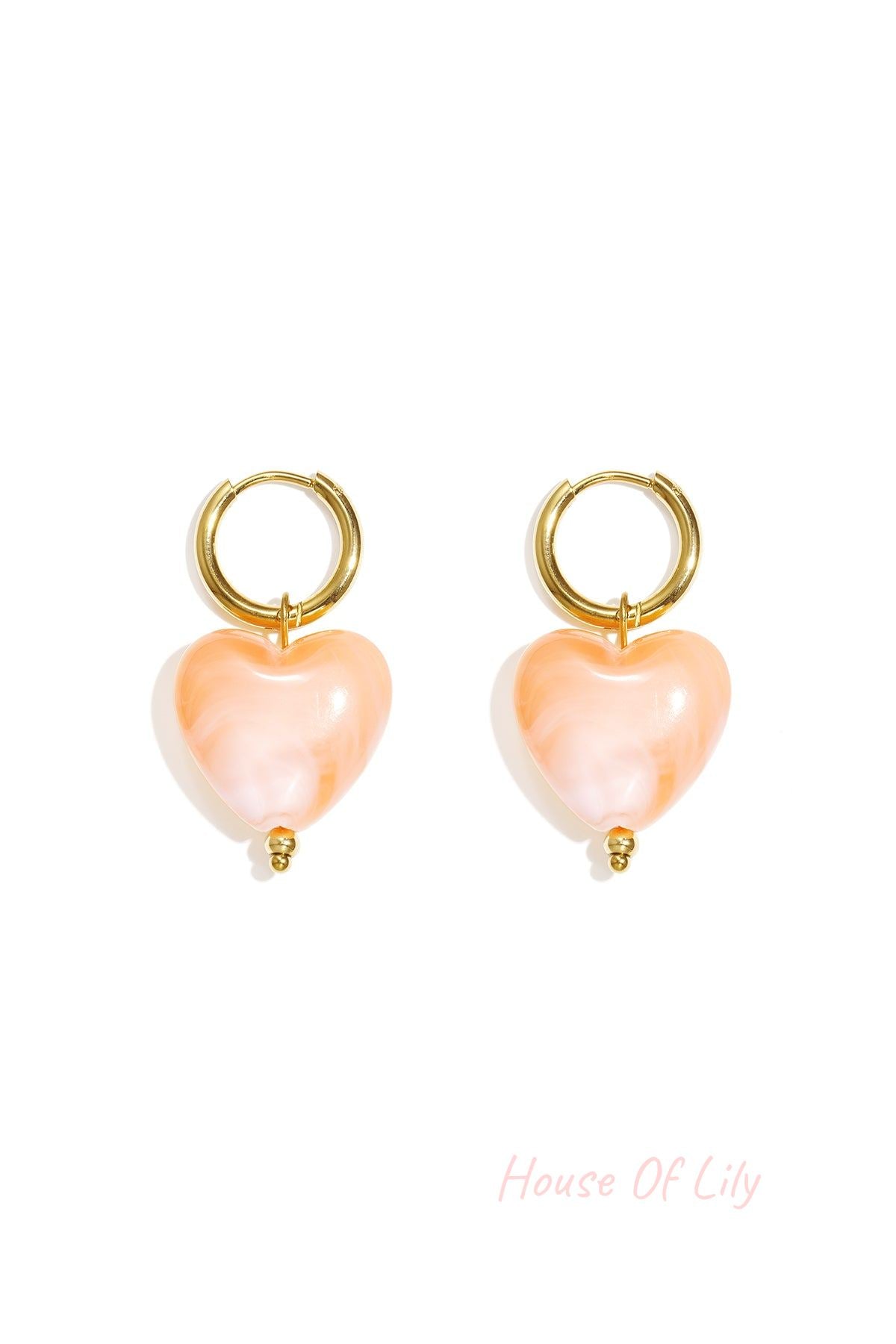Y2K gold hoop earrings featuring marbled peach-colored heart charms with a small gold bead detail.