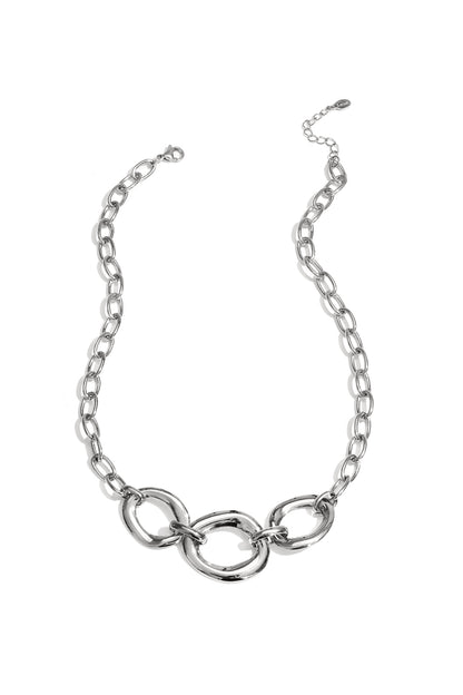 Silver chunky link necklace with three oversized rounded links and adjustable chain on white background