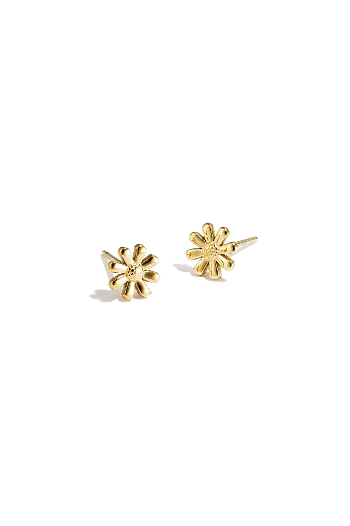 Pair of gold daisy flower stud earrings on white background