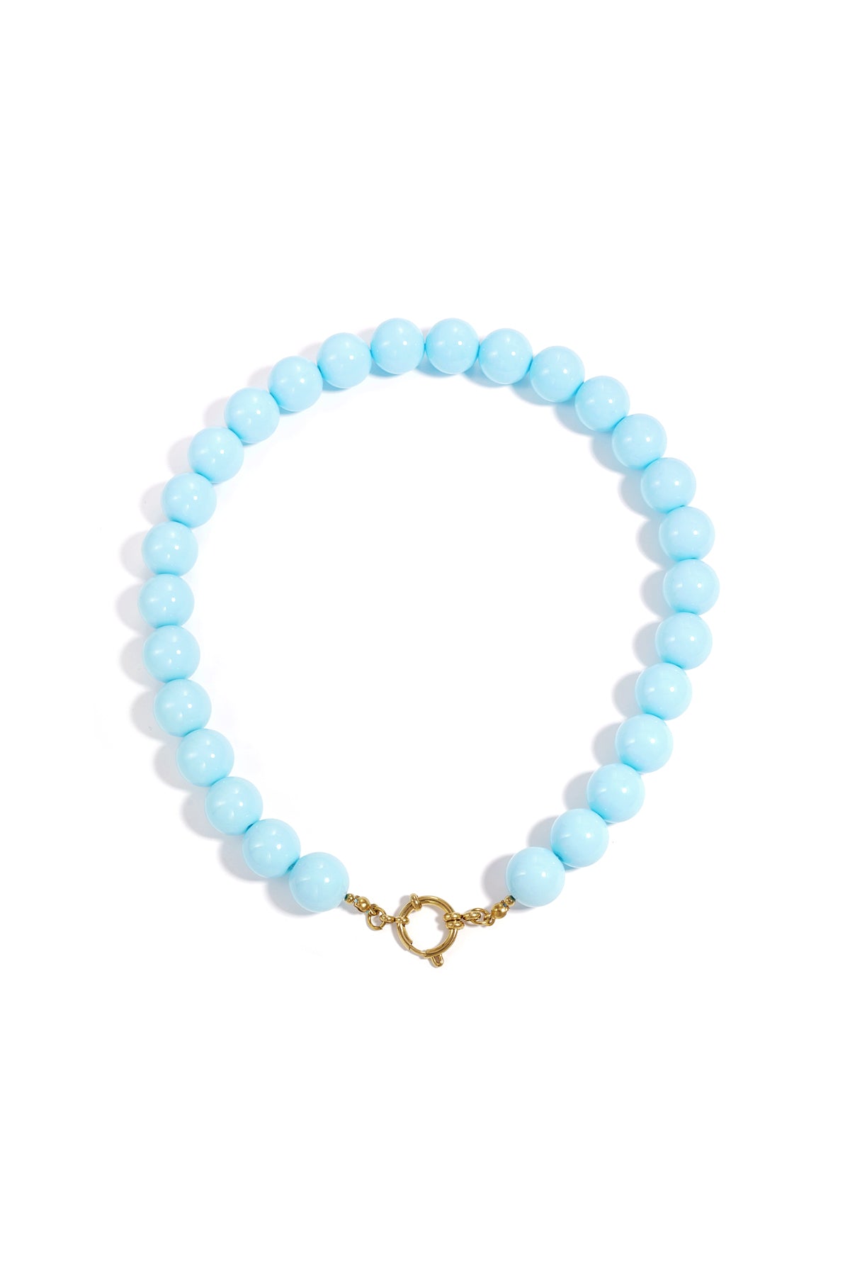 Chunky coral resin beaded necklace with gold clasp on white background
