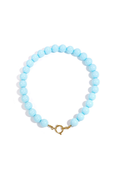 Chunky coral resin beaded necklace with gold clasp on white background