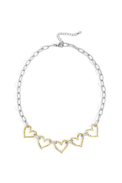 Two-tone heart link necklace with gold heart charms on silver chain laid flat on white background