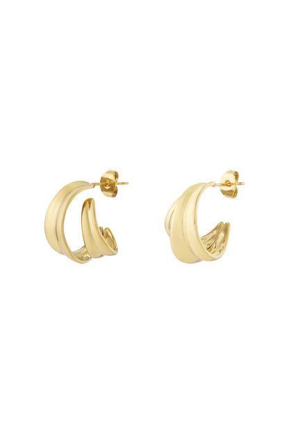 A pair of polished gold-tone curved sculptural hoop earrings with a smooth double-band design on a white background