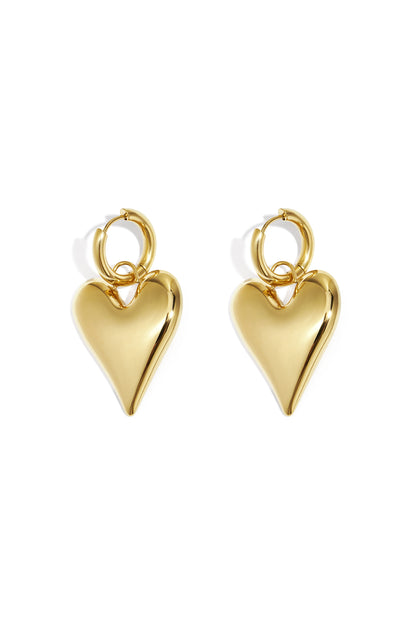 Pair of shiny gold chubby heart-shaped hoop earrings on white background