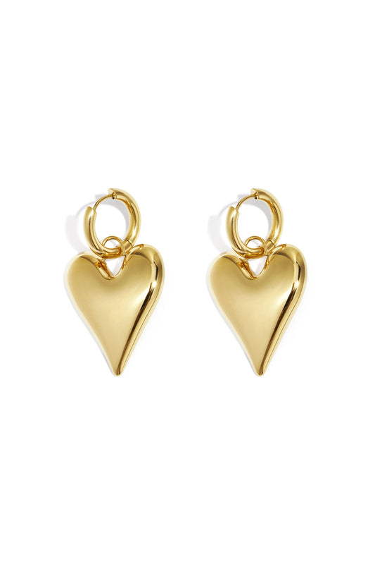 Pair of shiny gold chubby heart-shaped hoop earrings on white background
