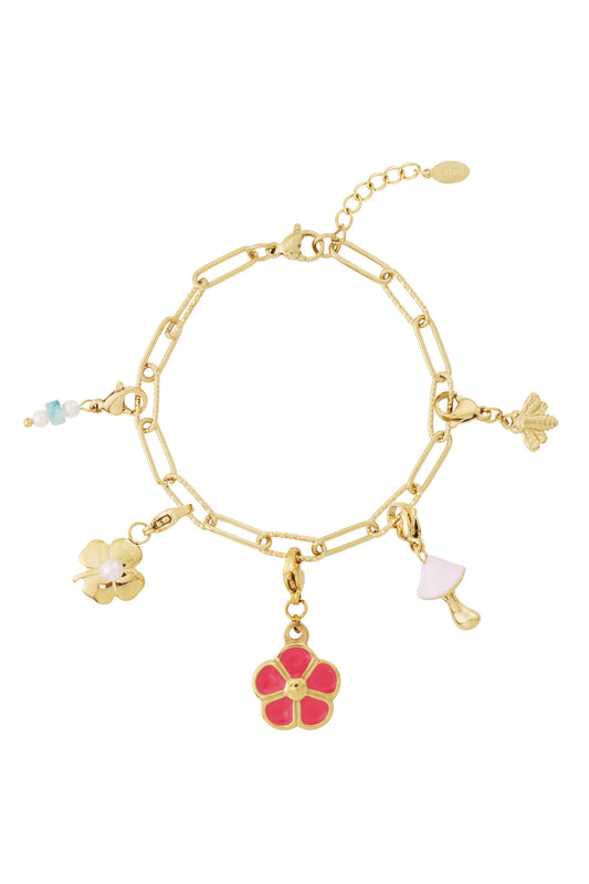 Gold link charm bracelet featuring whimsical charms: a pink flower, pearl clover, mushroom, bee, and beaded accent.