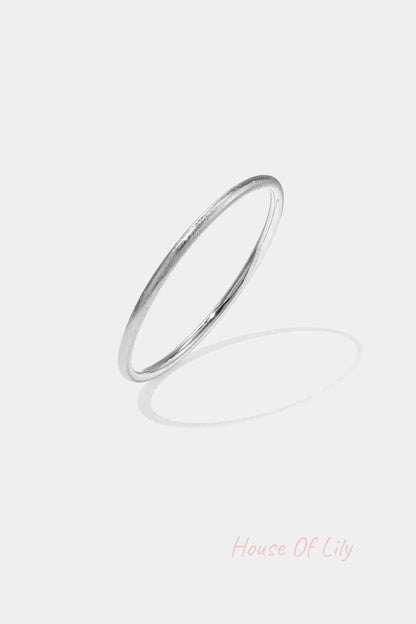 Minimalist silver circle bangle with a soft texture on white background
