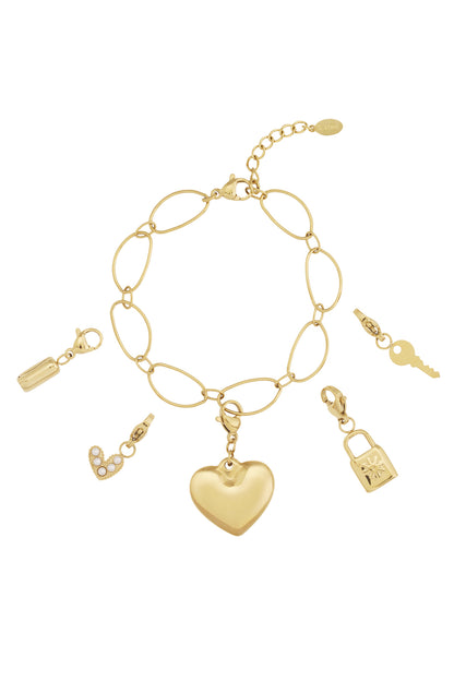 Golden link charm bracelet with five detachable gold charms including heart, key, lock, bottle and pearl heart on white background