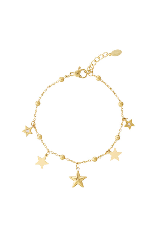 Gold star charm bracelet with multiple star and bead charms on a white background
