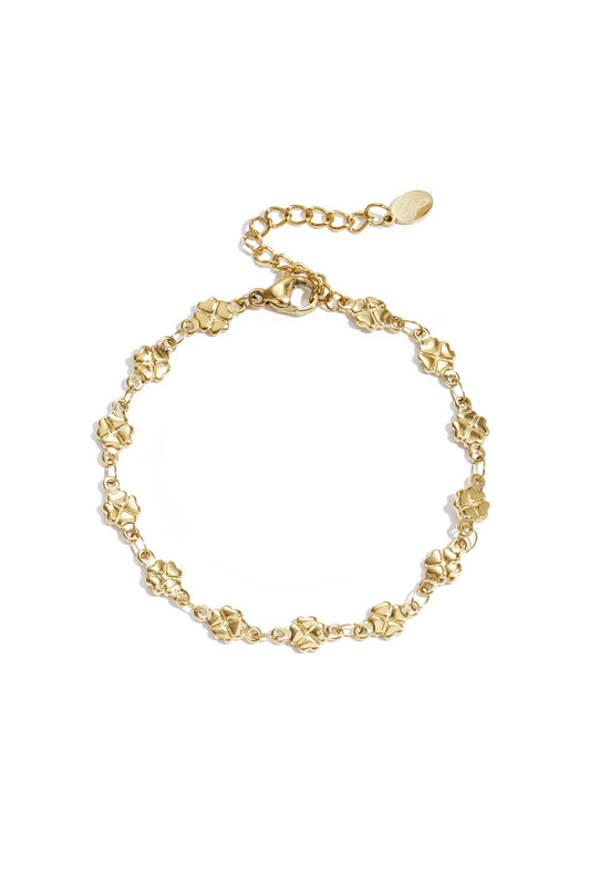 Gold bracelet featuring linked four-leaf clover charms with adjustable chain on white background