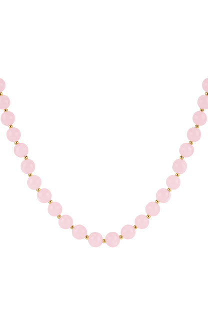 Close-up of soft blush pink glossy acrylic beaded necklace with gold spacers on white background