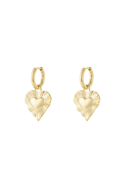 Pair of gold drop earrings with radiant heart-shaped charms featuring a textured fluted border on white background.