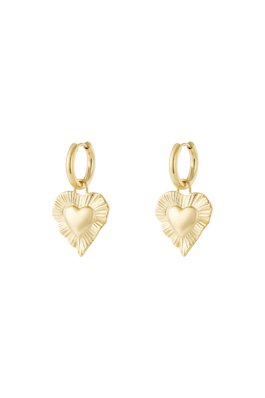 Pair of gold drop earrings with radiant heart-shaped charms featuring a textured fluted border on white background.
