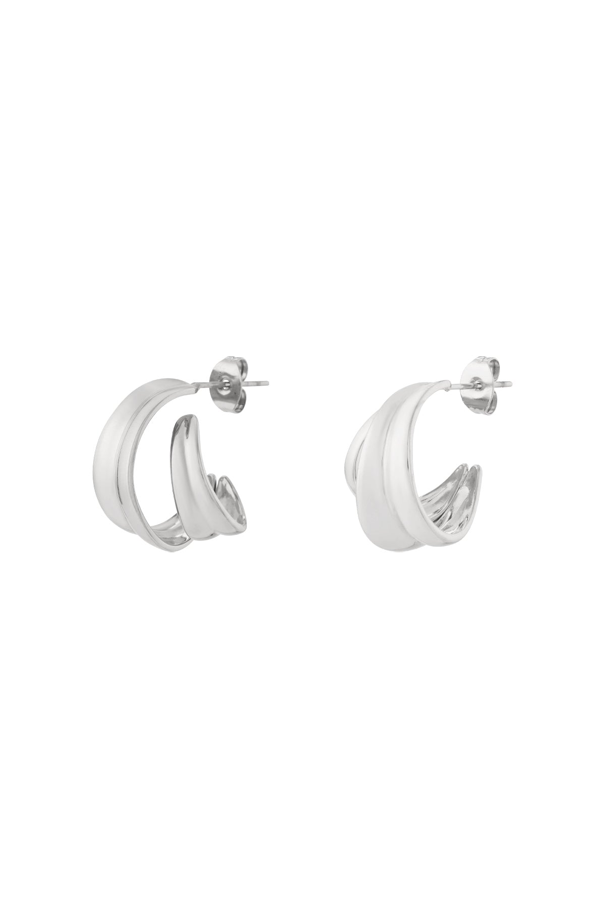 A pair of polished silver-tone curved sculptural hoop earrings with a smooth double-band design on a white background