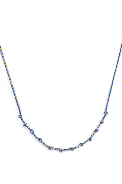 Blue knotted cotton necklace with gold accents laid flat on white background