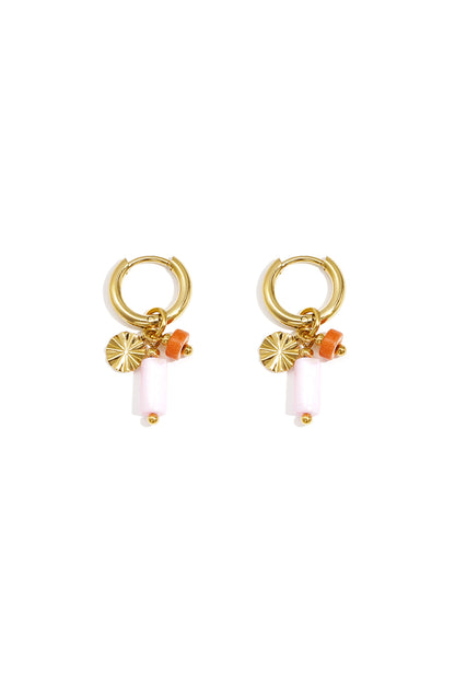 Gold-tone hoop earrings with orange and white stone beads and textured disc charm on white background