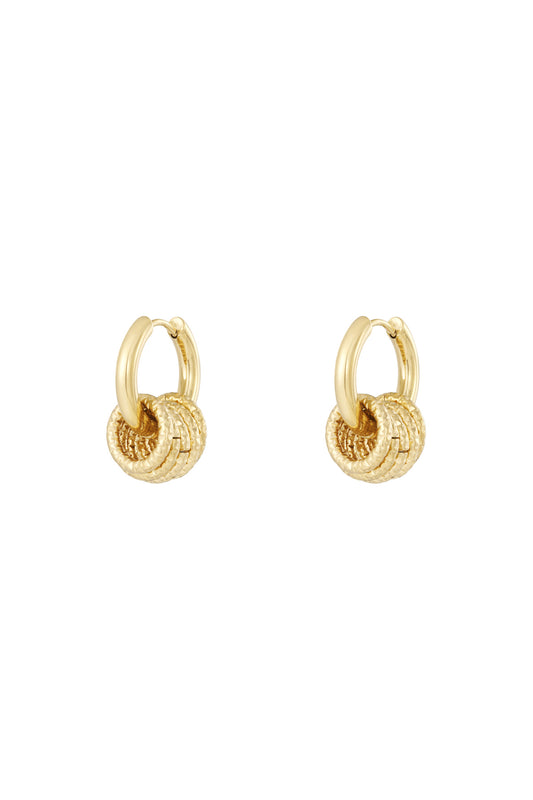Pair of gold textured hoop drop earrings isolated on white background