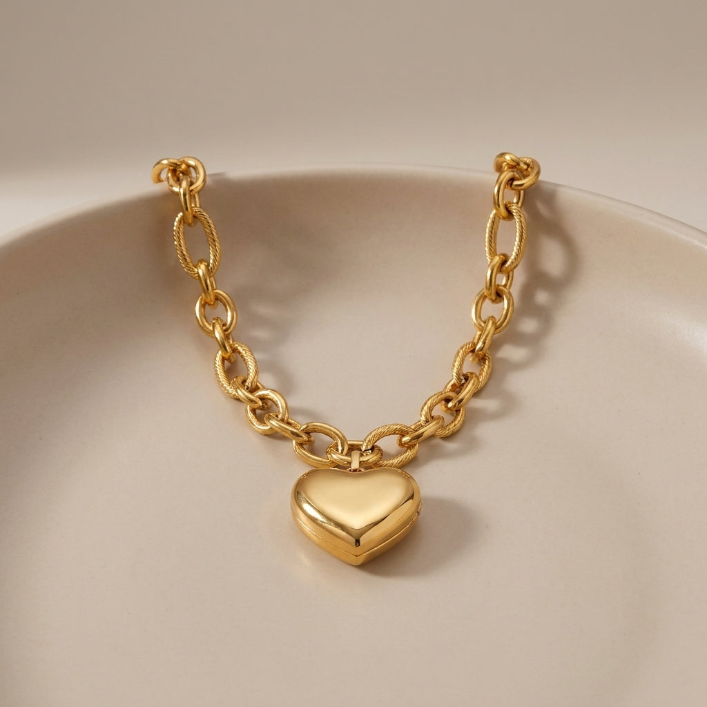 Gold Heart Melter pendant necklace featuring a smooth, puffy heart charm on a chunky, textured oval-link chain.
