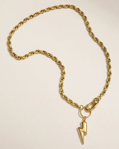 Gold tone rope chain necklace with a glossy lightning bolt pendant and clasp on a light background.