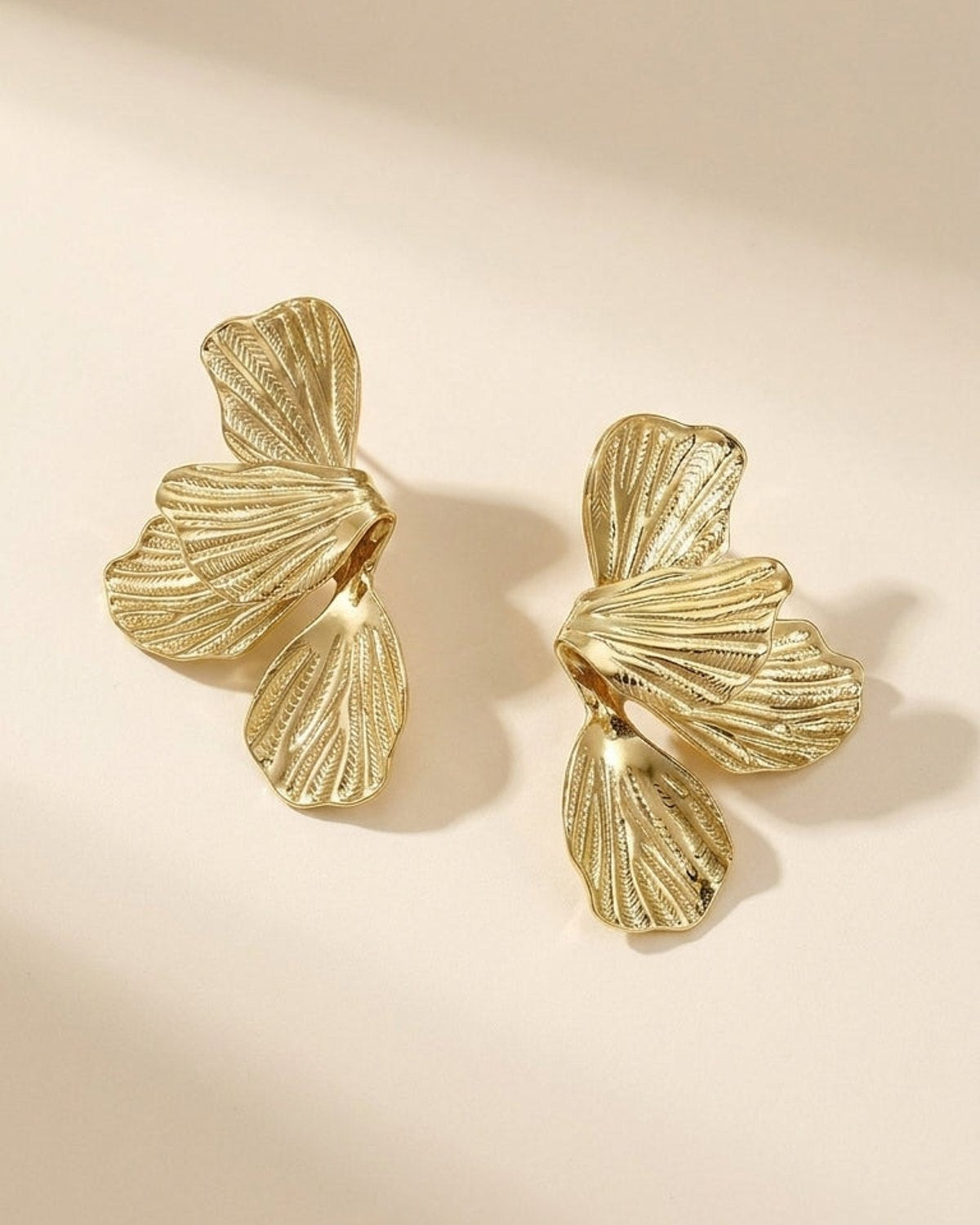 Gold Flower Drop Earrings with textured, overlapping petal-shaped metal segments.