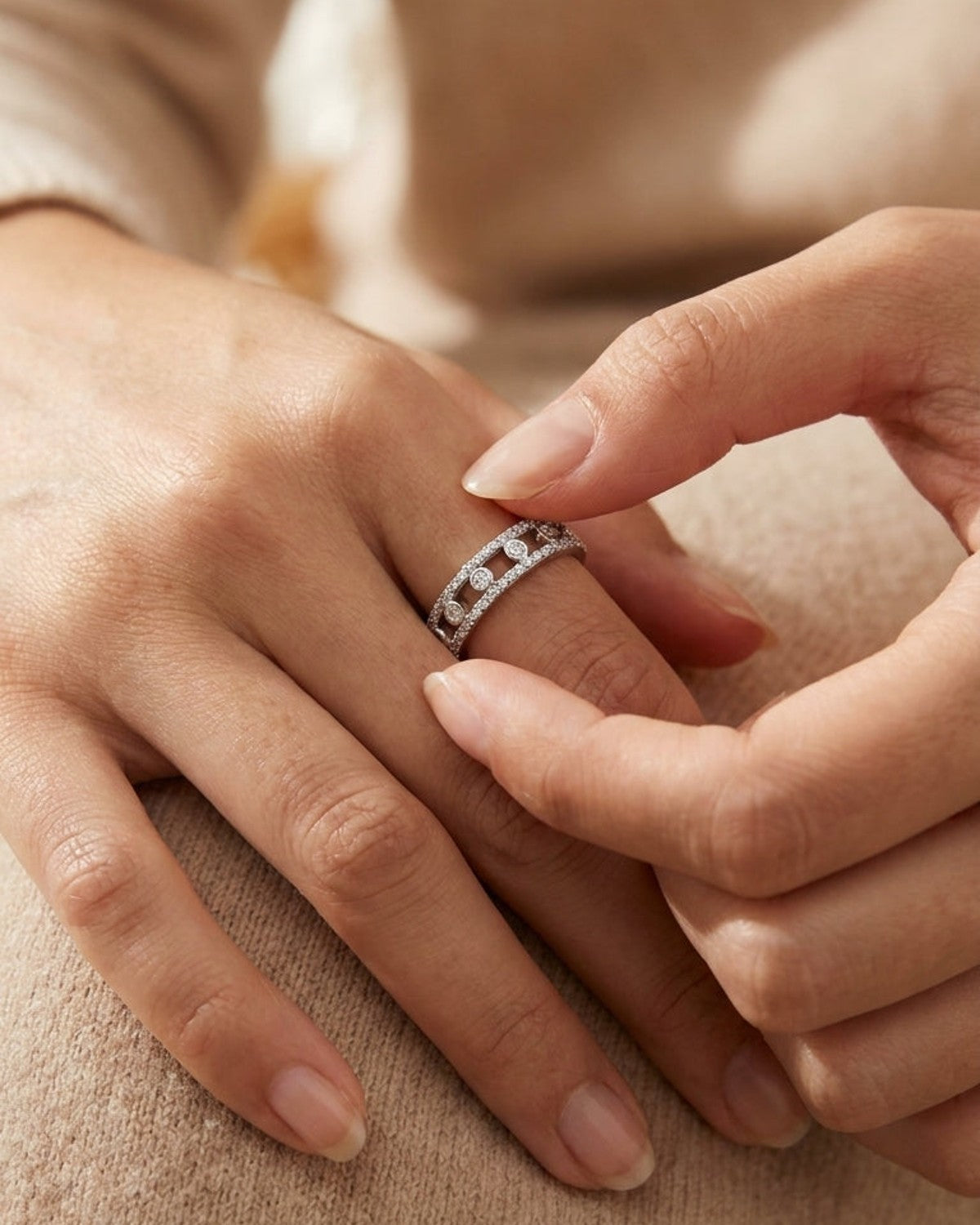 Sleek Circle Ring worn on a finger, featuring a silver band pavé-set with small stones and spaced circular motifs.