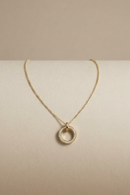 Gold Dual Tone Circle necklace featuring a pavé-set ring pendant suspended from a fine chain link.