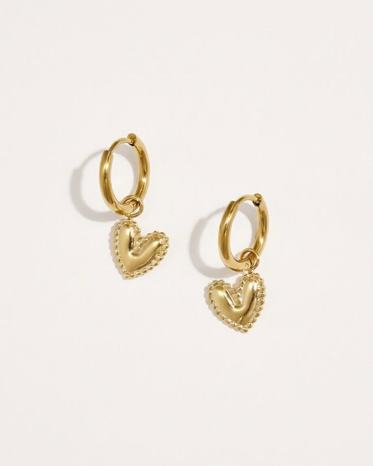 Heart Drop Earrings: gold hoop earrings featuring puffy heart pendants with beaded borders.