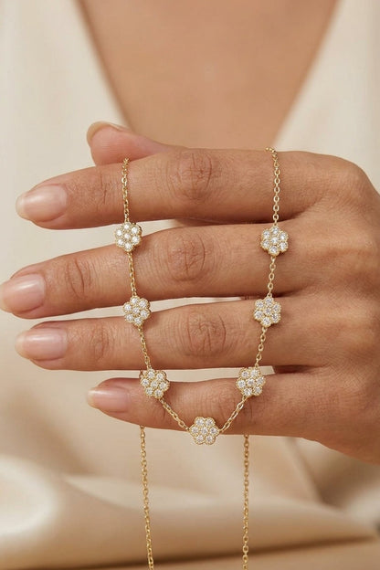 Gold chain necklace featuring multiple pavé-set zircon floral stations.