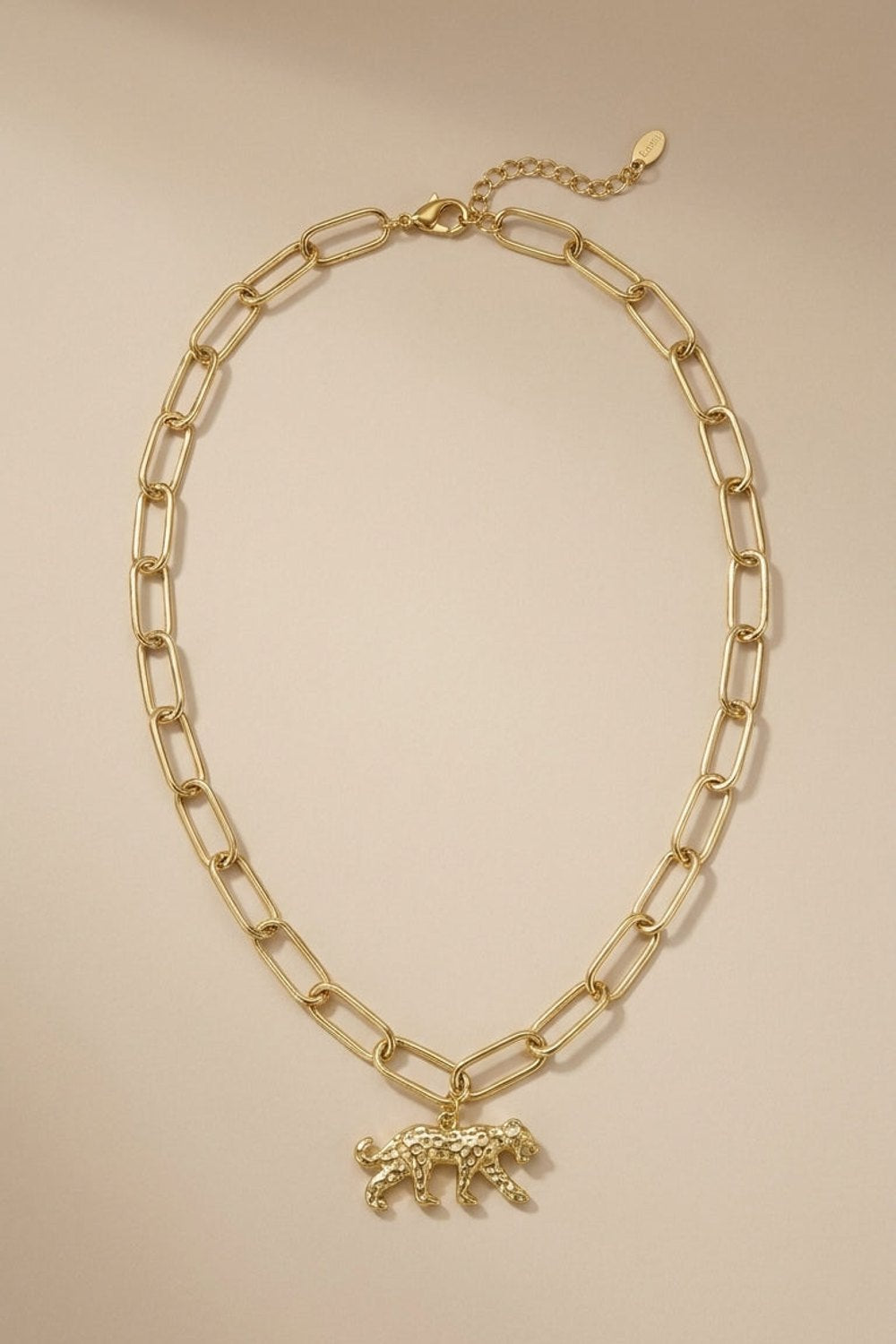 Gold-tone link chain necklace featuring a textured leopard pendant.