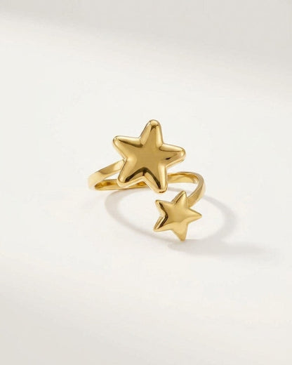 Gold minimalist star ring with an open band featuring one large star and one smaller star.