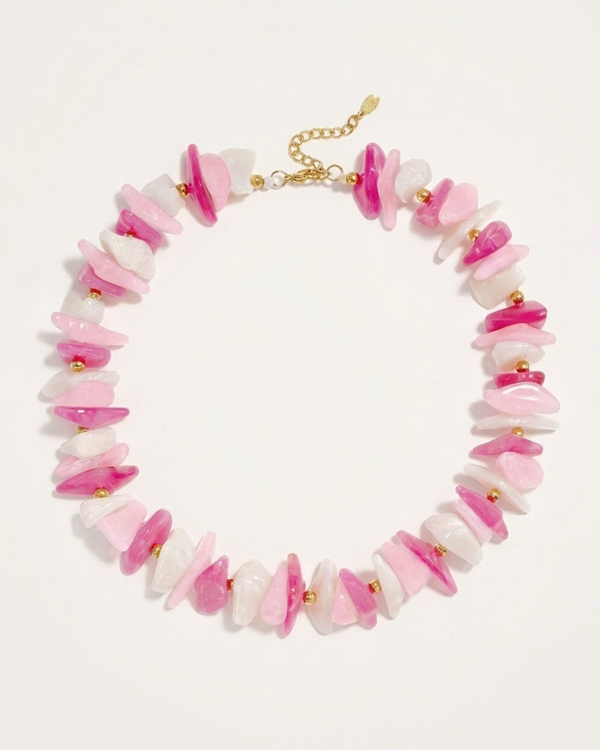 Multi stone chip bead necklace in pink, white, and magenta with gold-tone metal accents and clasp.