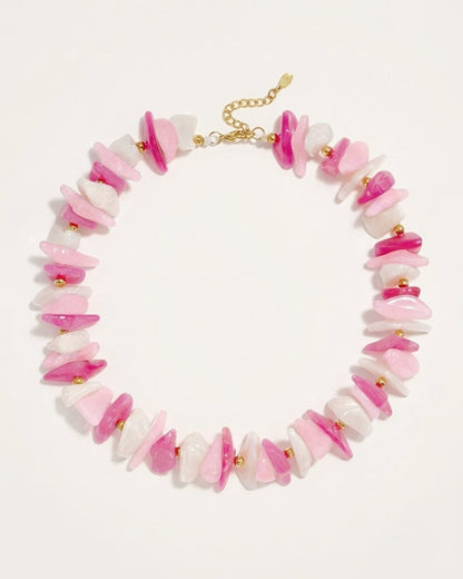 Multi stone chip bead necklace in pink, white, and magenta with gold-tone metal accents and clasp.