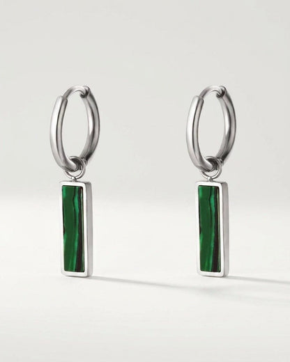 Silver hoop earrings featuring a dangling rectangular bar inlay with green and black banded stones.