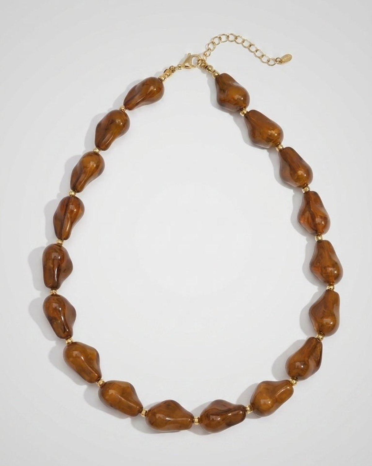 Chunky brown marbled beaded necklace with irregular resin beads separated by small gold accents.