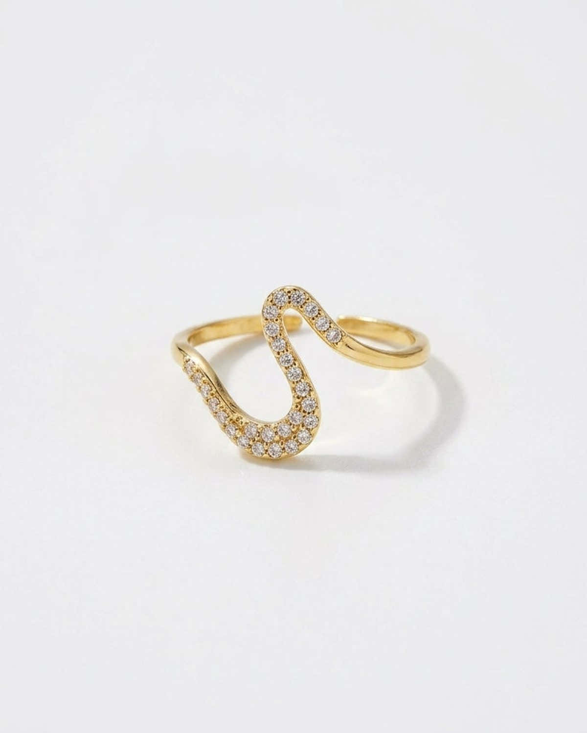 A gold Rhinestone Line Ring with an open, wavy band paved with sparkling rhinestones.