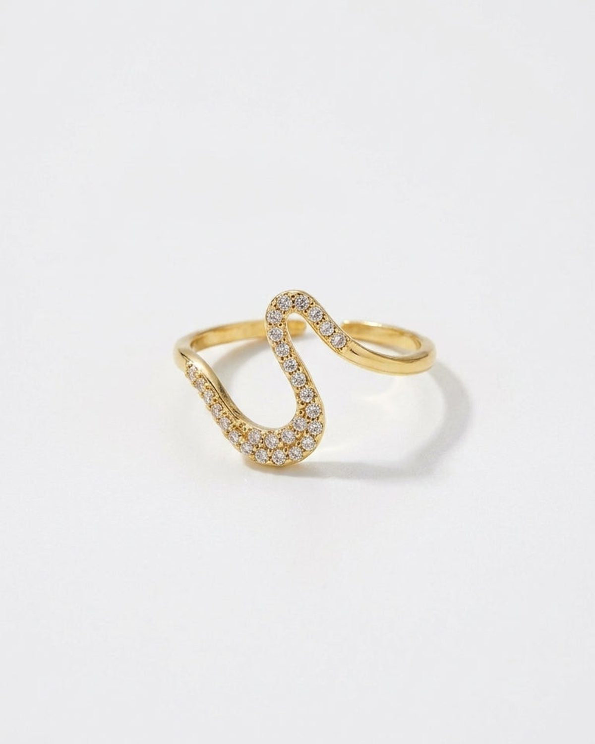 A gold Rhinestone Line Ring with an open, wavy band paved with sparkling rhinestones.