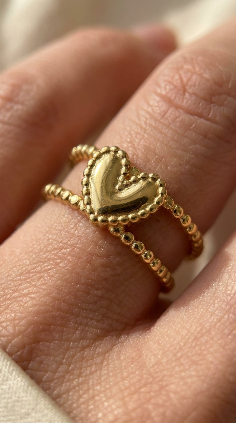 Gold Double Trouble ring featuring a puffy heart center with a beaded border on a dual-beaded band.