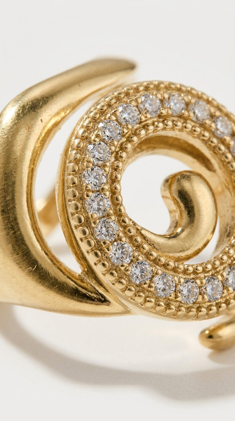Coastal gold spiral ring with a beaded band encrusted with clear pavé crystals.