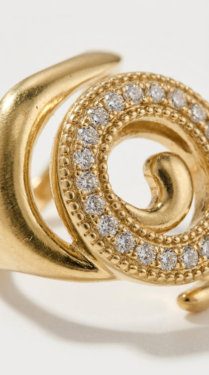 Coastal gold spiral ring with a beaded band encrusted with clear pavé crystals.