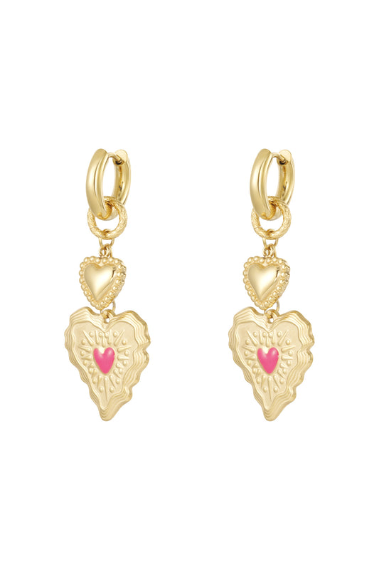 Pair of gold heart drop earrings with textured double hearts and pink center detail on white background