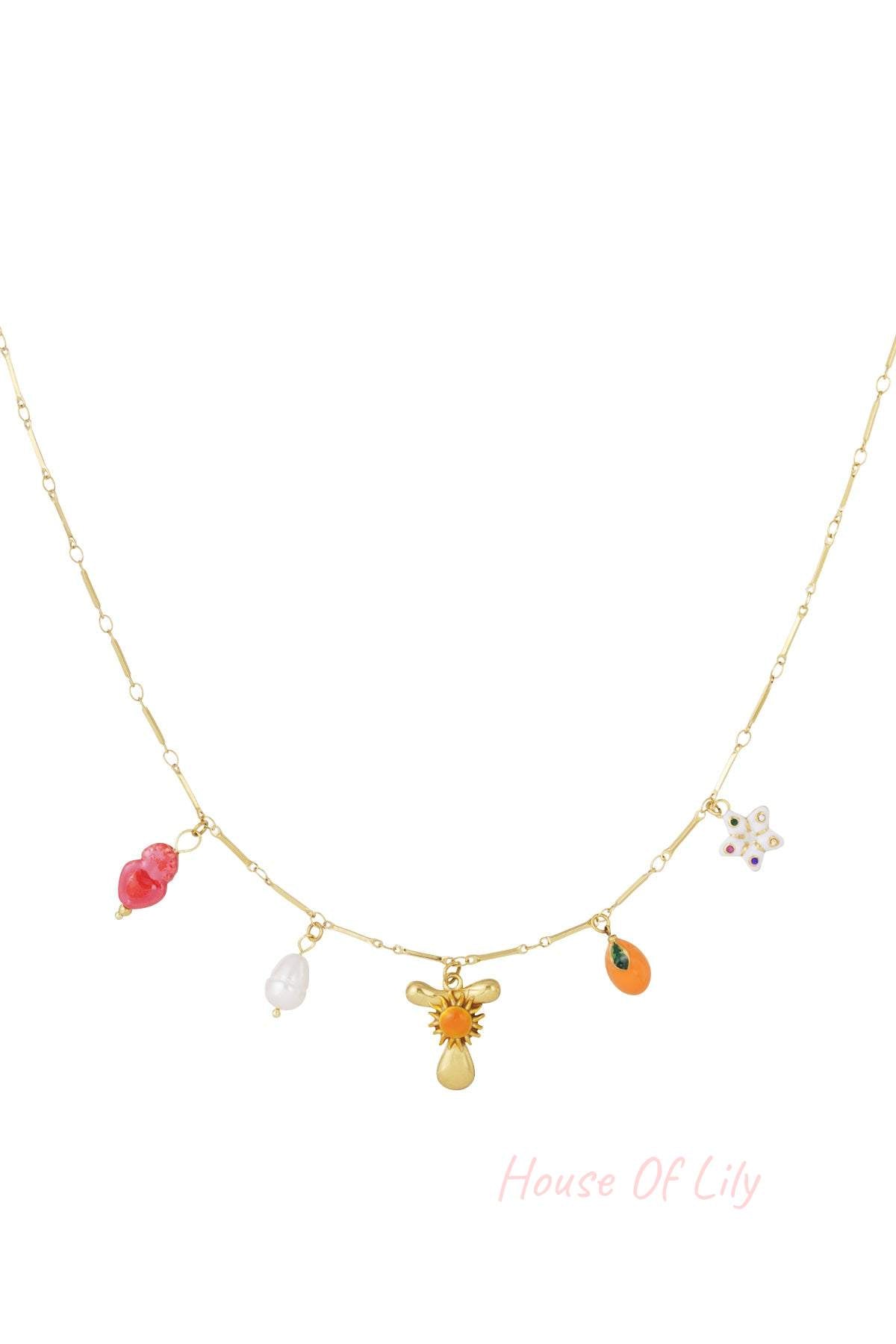 Gold chain necklace featuring a variety of colorful charms: a heart, pearl, sunburst, fruit, and floral star.