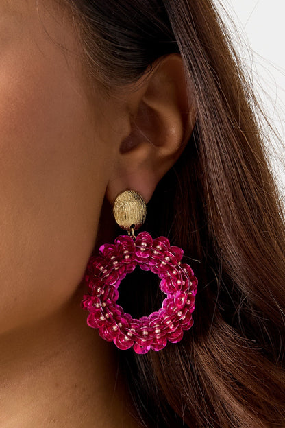 Drip In Disco earrings: Gold-textured stud with a large, vibrant pink sequin hoop, worn on an ear.