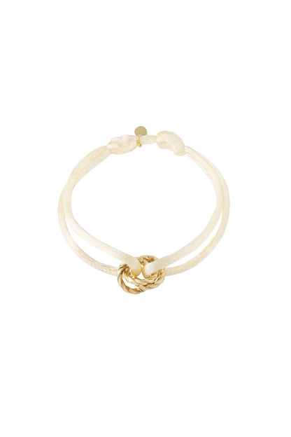 Purple knot charm bracelet with gold-plated twisted knot pendant on white background
